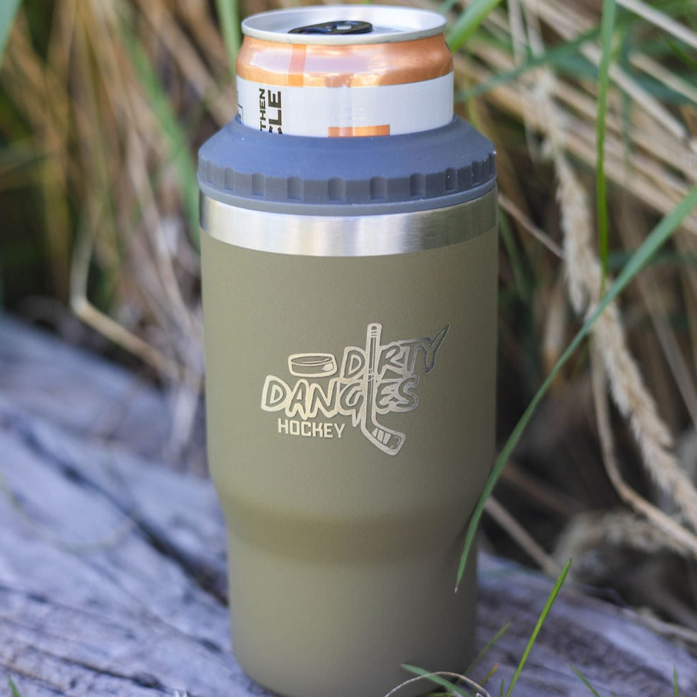 A green dirty dangles hockey 12 oz 4 in 1 tumbler drink cooler combo outdoors on a log