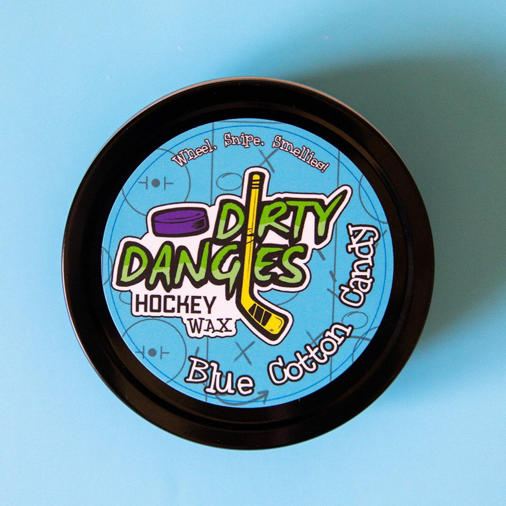 A tin of Dirty Dangles Hockey Stick Wax Blue Cotton Candy Scent sits on a blue background.