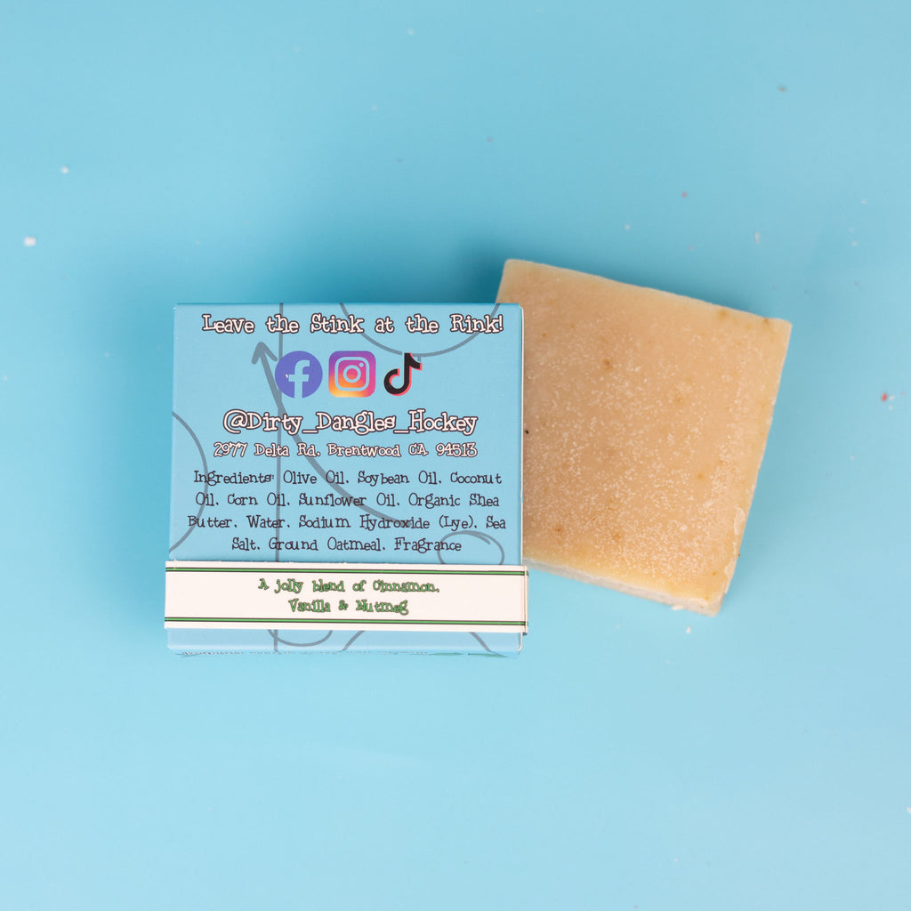 The back of a box of dirty dangles top shelf christmas hockey soap bars on a blue background.