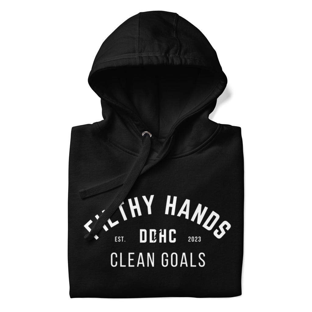 A folded black hoodie on a white background. Filthy hands clean goals dd/hc