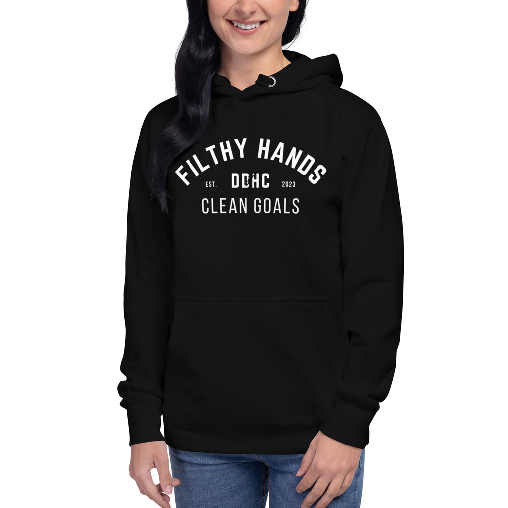 A woman in jeans wearing a black hoodie. Filthy hands clean goals dd/hc