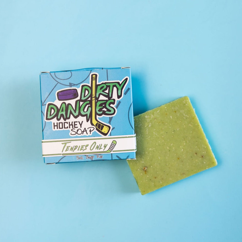 A green bar of dirty dangles hockey soap Tendies Only scent on a blue background with a blue box