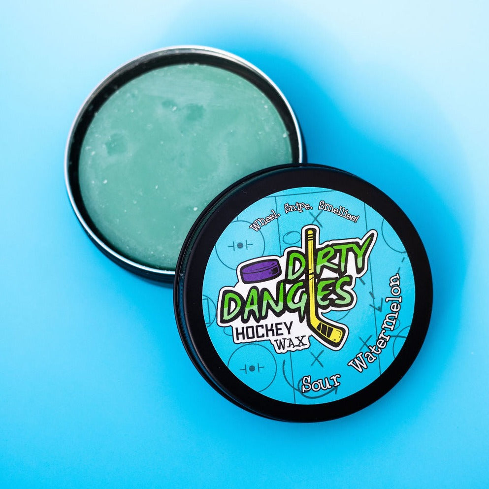 An open tin of dirty dangles sour watermelon scent stick wax on a blue background