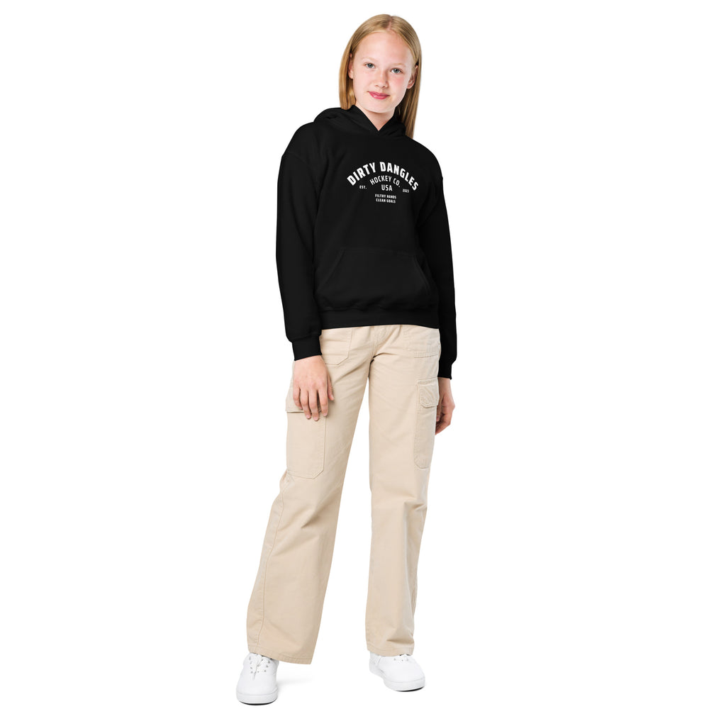 A girl in tan pants on a white background in a black hoodie. Dirty dangles hockey co.