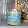 An orange dirty dangles hockey candle lava monster scent sitting on a shelf with decorations.