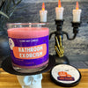 Candle labeled 'Bathroom Exorcism' by Stank Away Candles on a skull stand with a candelabra in the background.
