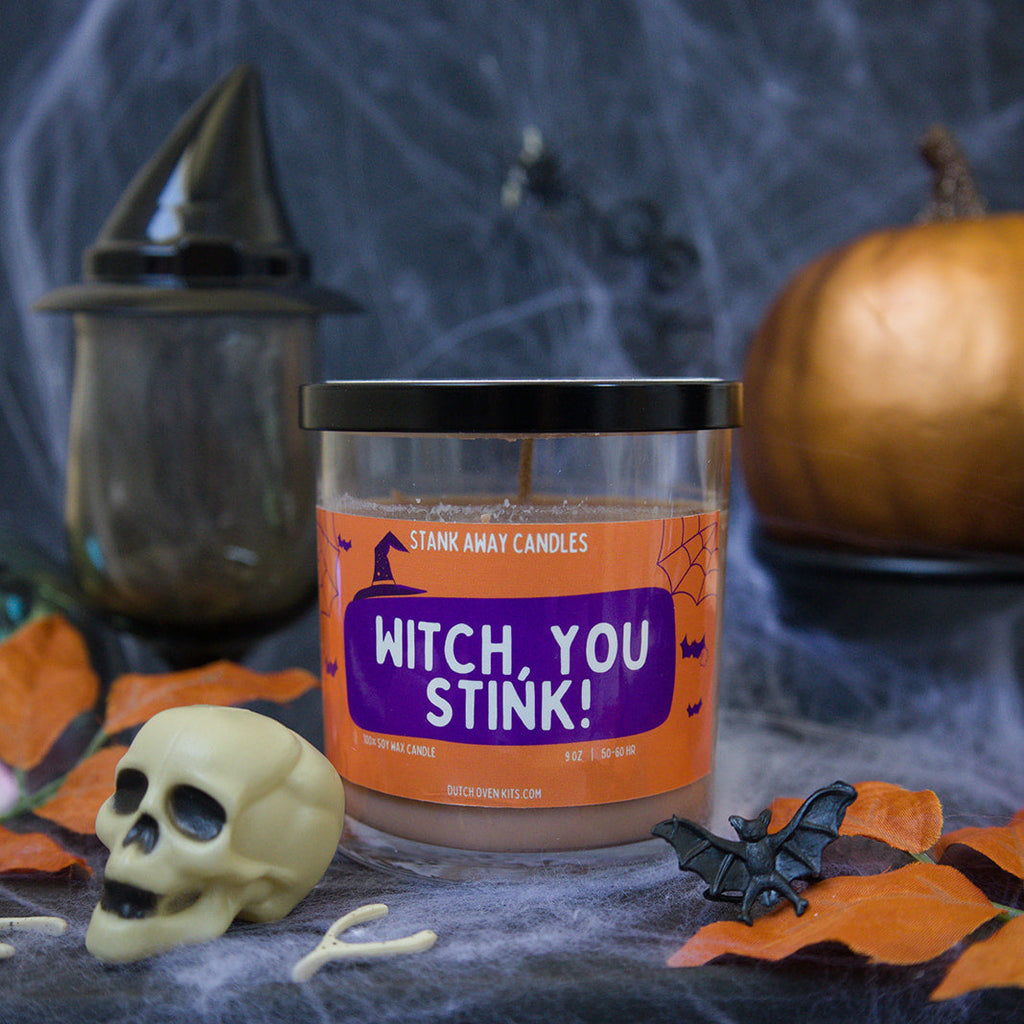Halloween-themed candle with decorative elements on a dark background