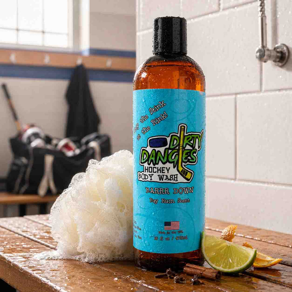 Bottle of Dink Dangles hockey body wash with a blue label on a wooden surface.
