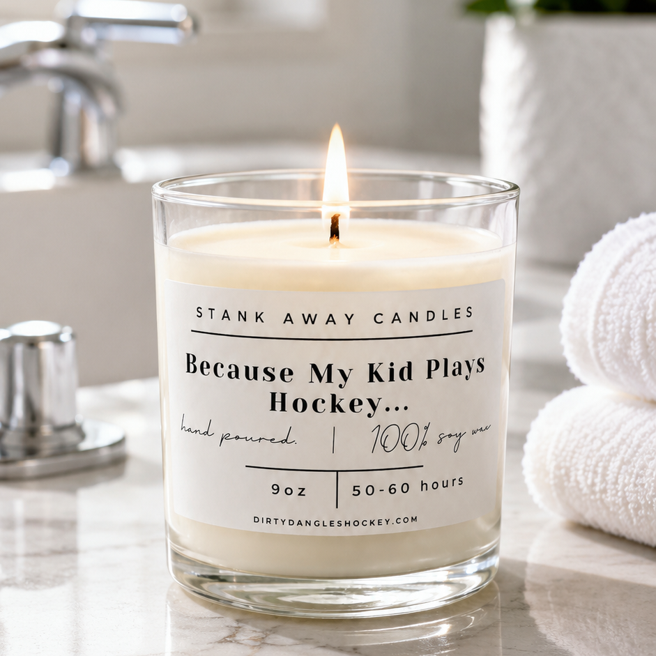 A white scented hockey candle in a bathroom. Because my kid plays hockey.... 