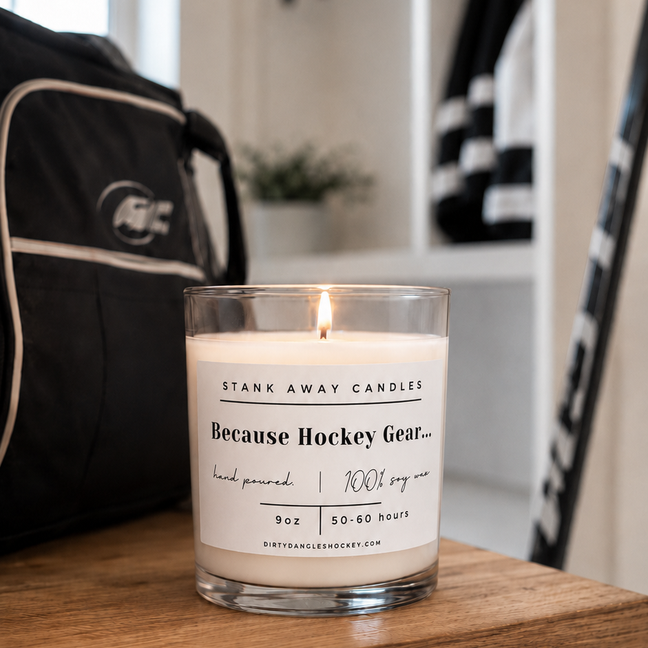 A white scented hockey candle on a wooden bench. Because Hockey Gear