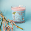 A purple dirty dangles girls and womens hockey candle certified beaut lavender lemongrass scent on a blue background with lavender  and lemongrass