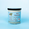A green dirty dangles natural hockey candle sour watermelon scent on a blue background