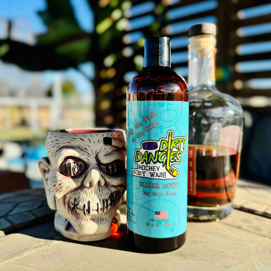 A bottle of dirty dangles hockey body wash Barrr Down scent with a bottle and zombie drink mug