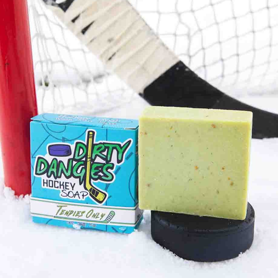 A green soap bar on a snowy background with  a hockey stick, puck and goal. Tendies Only