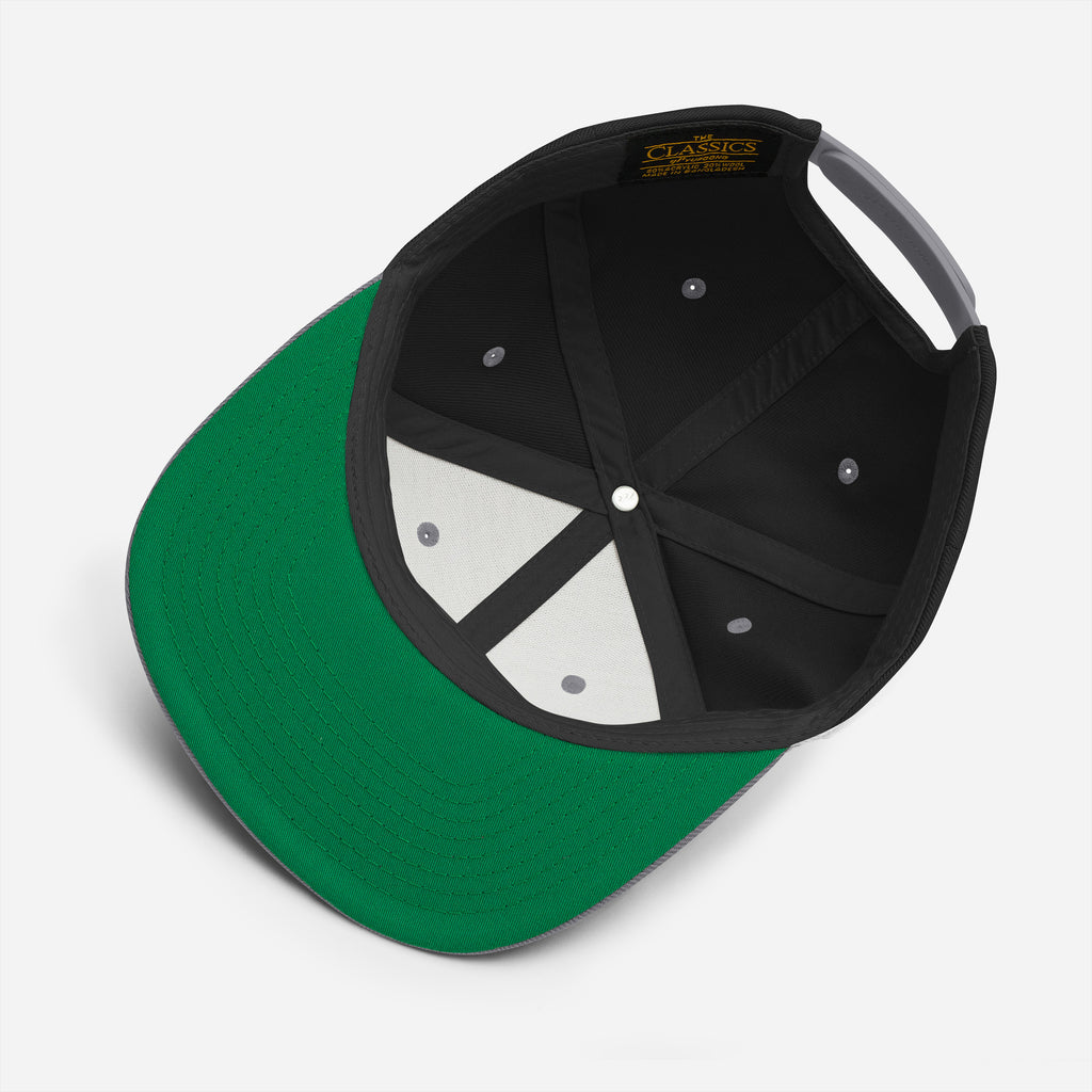 The inside of a black flat brim hat with a green underbrim on white background.. Filthy hands clean goals