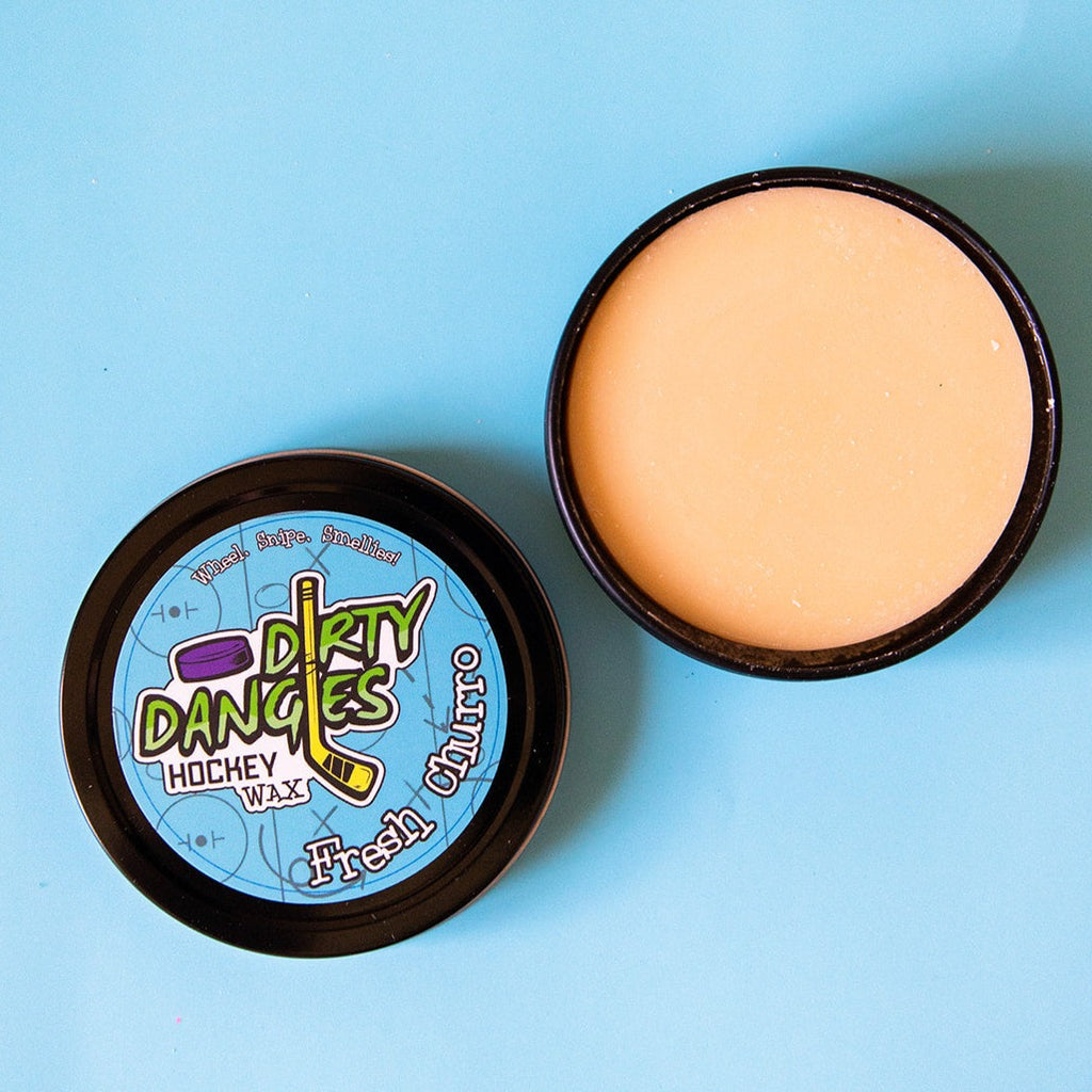Fresh churro scented  Hockey Stick wax open on a blue background showing a tan stick wax.