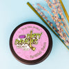 A tin of dirty dangles girls and womens hockey stick wax on a blue background with lavender and lemongrass