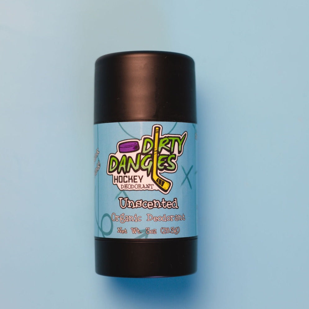 A tube of dirty dangles natural probiotic deodorant on a blue background. Unscented scent.