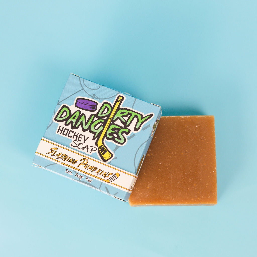 a box of dirty dangles slashing pumpkins pumpkin spice soap bars on a blue background