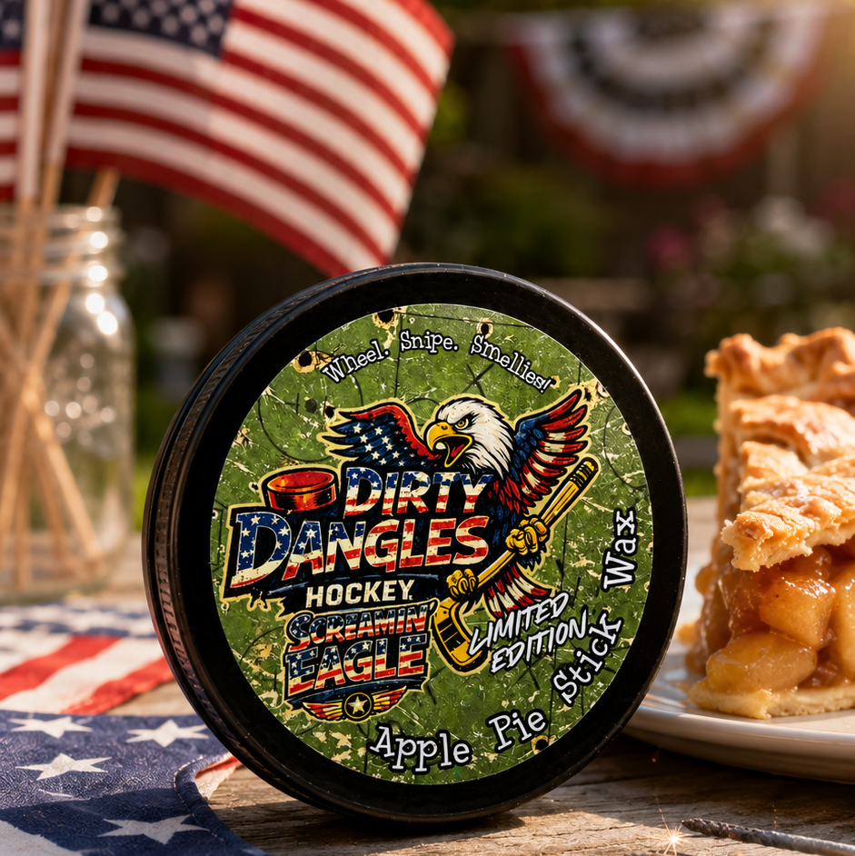 A tin of dirty dangles screamin eagle 4th of july stick wax on a picnic table with apple pie and american flags
