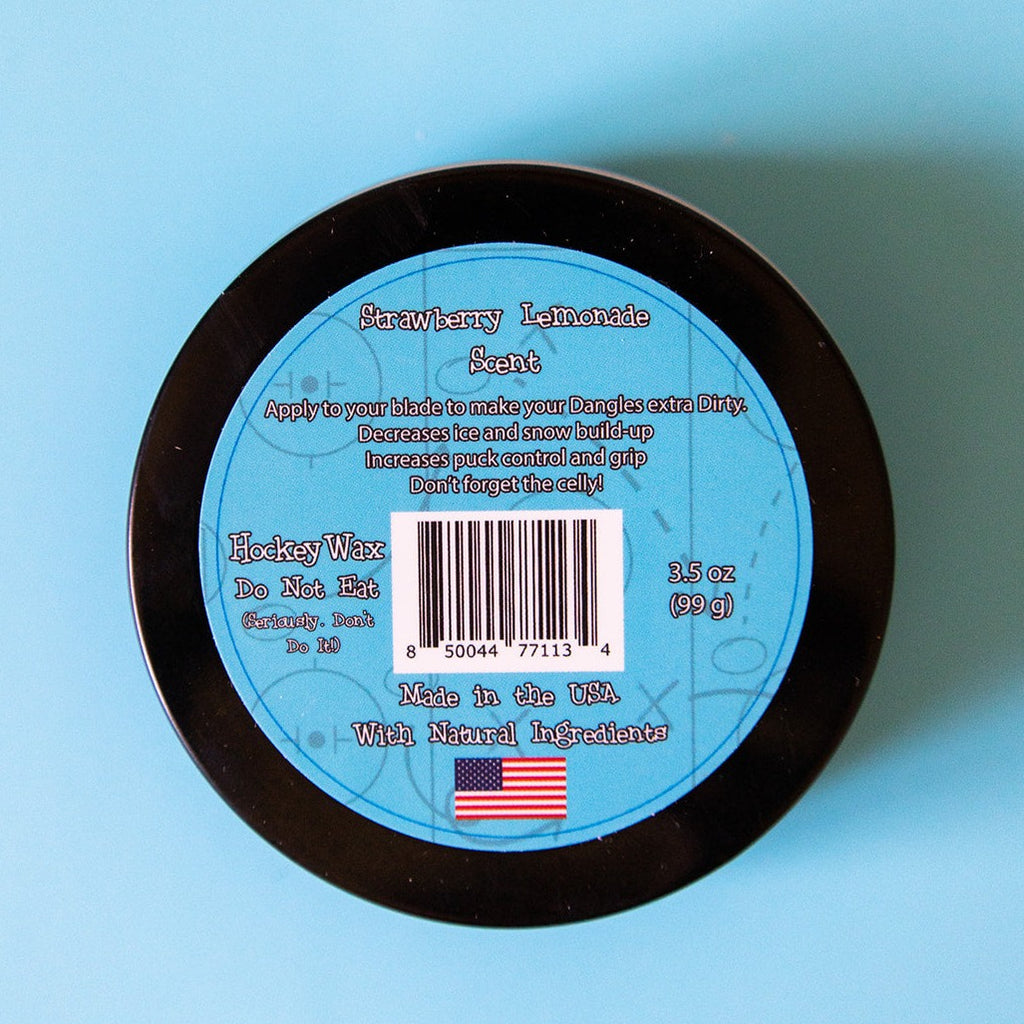 The back of a tin of Dirty Dangles Hockey Stick Wax Strawberry Lemonade Scent sits on a blue background.