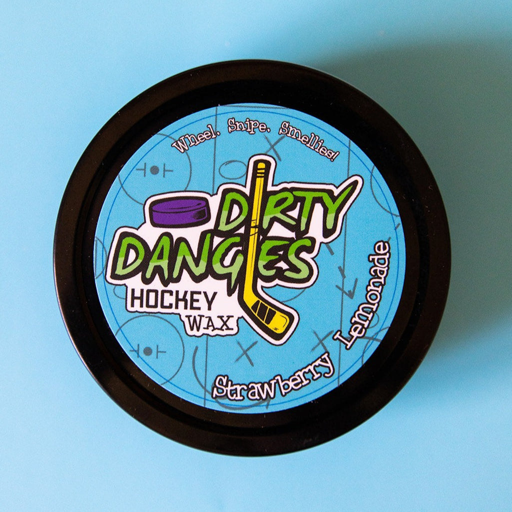 A tin of Dirty Dangles Hockey Stick Wax Strawberry Lemonade Scent sits on a blue background.