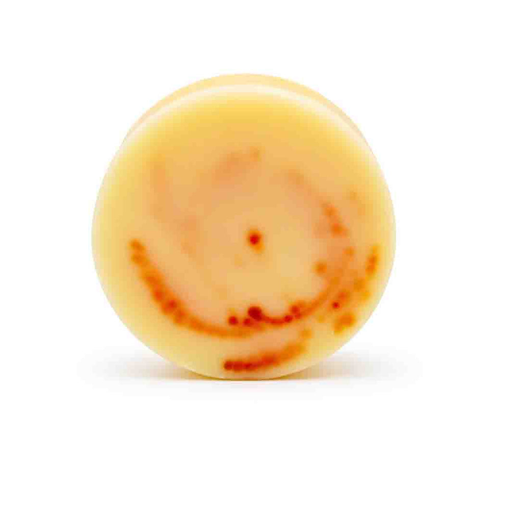 A yellow and orange swirl Dirty dangles tiki deke limited edition tropical stick wax without packaging on a white background.