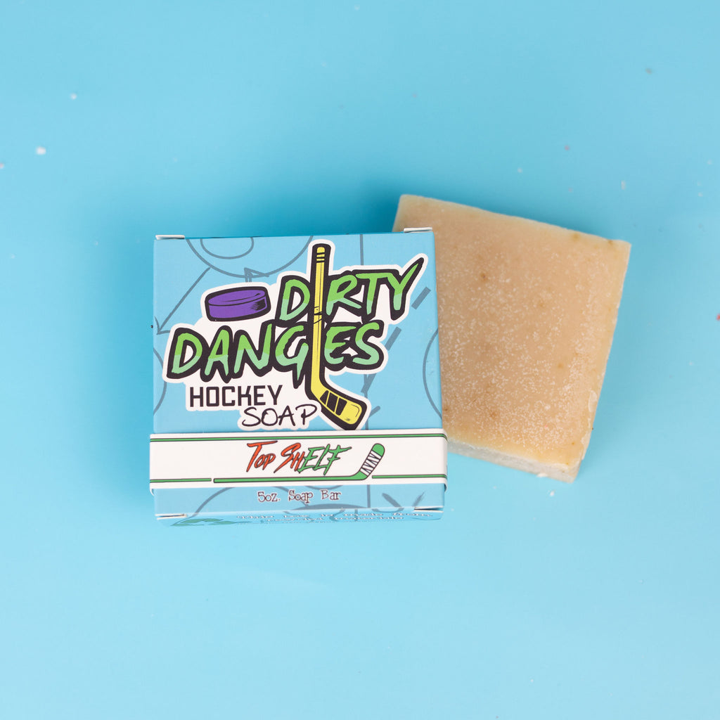 The front of a box of dirty dangles top shelf christmas hockey soap bars on a blue background.