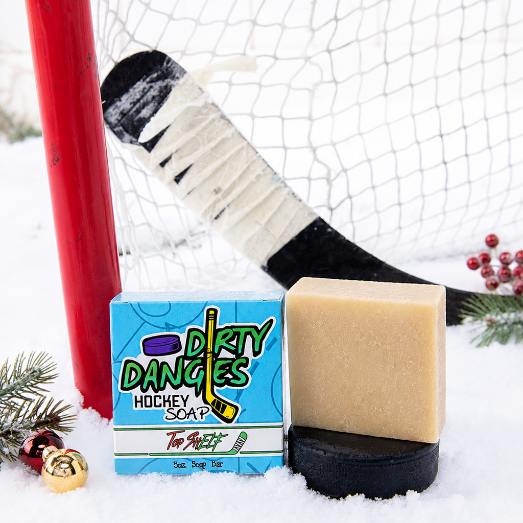 top shelf christmas oatmeal spice hockey soap bar with blue box in the snow with hockey gear and christmas decorations.