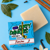 Barrr down bay rum scented hockey soap bar on a blue background with cinnamon, vanilla and bay leaves.