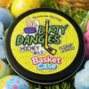 Tin of Dirty Dangles Basket Case marshmallow candy scented hockey wax with Easter eggs and a basket in the background