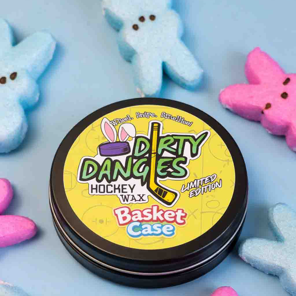 Dirty Dangles Hockey Wax Basket Case marshmallow candy scented hockey wax surrounded by colorful marshmallow Peeps on a light blue background