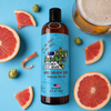 a bottle of beer league hero grapefruit pale ale hockey body wash on a blue background with grapefruit, hops and a pale ale.
