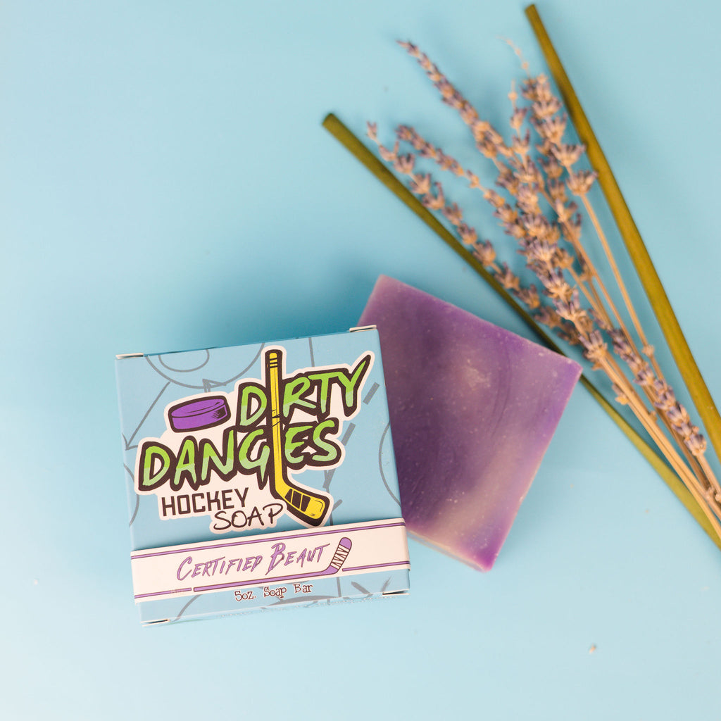 certified beaut lavender lemongrass girl's soap bar on a blue background with lavender flowers and lemongrass sticks