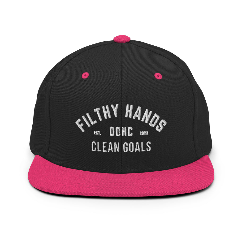 A black and neon pink flat brim hat on white background.. Filthy hands clean goals