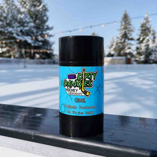 a stick of dirty dangles odr scent deodorant on the boards of an outdoor ice rink.