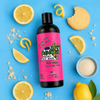 a bottle of goal digger girls lemon sugar cookie scented hockey body wash with a pink label on a blue background with lemons, sugar and cookies.