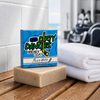 a brown silky mitts oatmeal milk and honey hockey soap bar in a locker room with a clean towel and hockey gear