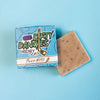 a brown silky mitts oatmeal milk and honey hockey soap bar on a blue background with a blue box