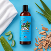 a bottle of sneaky dekes fresh linen aloe and sandalwood scented hockey body wash on a blue background with clean linen, aloe and sandalwood chunks