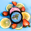 A tin of Dirty Dangles Hockey Stick Wax Strawberry Lemonade Scent sits open on a blue background surrounded by Strawberries and lemons