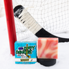 a pink, orange and white bar of tiki deke tropical coconut girls hockey soap on a snowy background with a hockey stick and hockey goal.