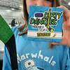 A girl hockey player holding a bar of tiki deke tropical coconut hockey soap inside an ice rink