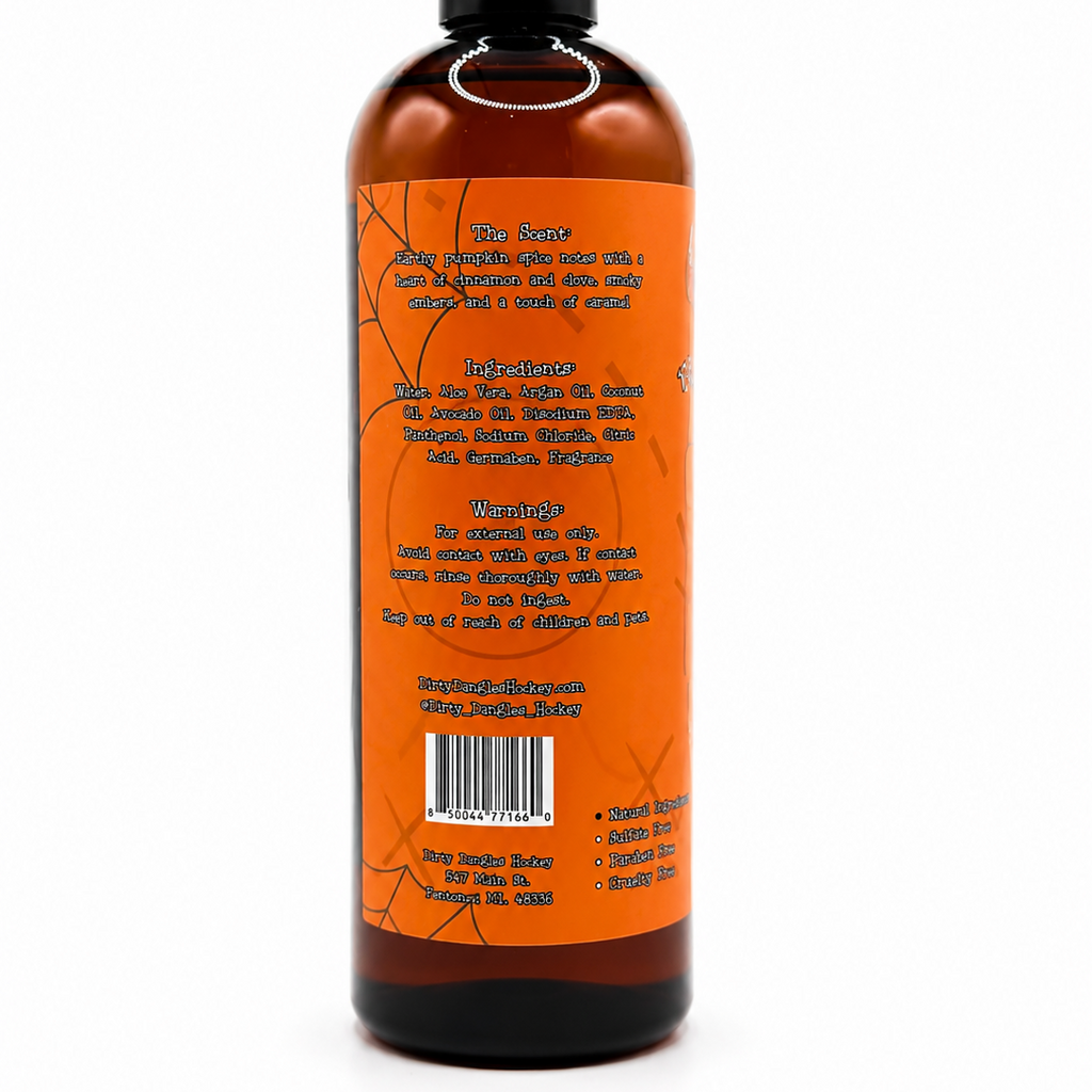 A 16oz amber plastic bottle of dirty dangles zombie sweat pumpkin spice body wash with a black cap, showing the back label on a white background.