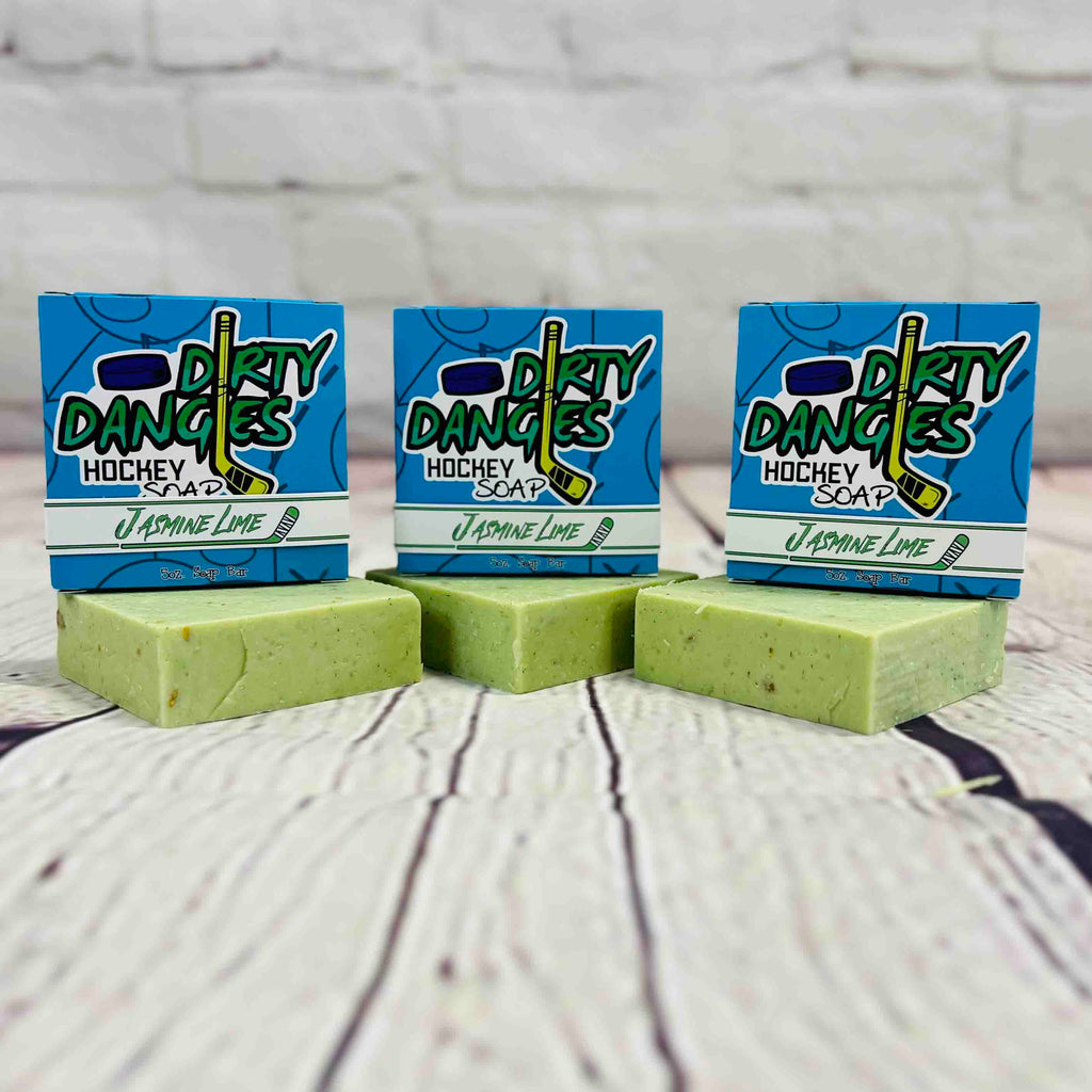 3 bars of dirty dangles jasmine lime scent soap against a wood and brick background. Dirty Dangles hockey soap.
