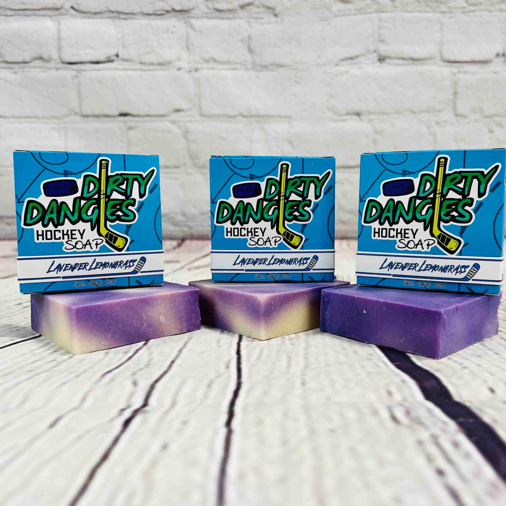 3 bars of dirty dangles lavender lemongrass scent soap against a wood and brick background. Dirty Dangles hockey soap.