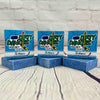 3 bars of dirty dangles the michigan scent soap against a wood and brick background. Dirty Dangles hockey soap.